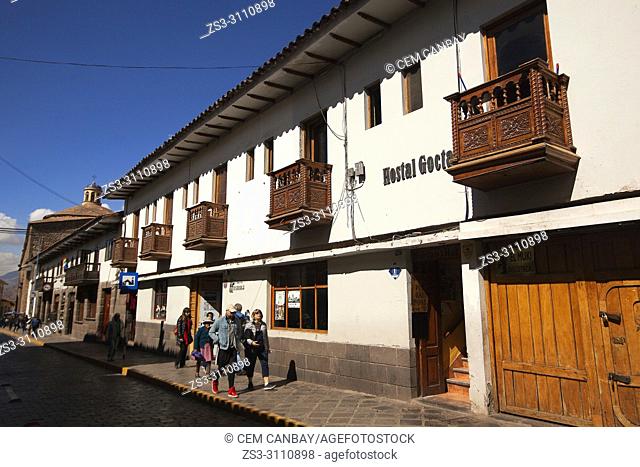 Tourists in front of the colonial buildings with balconies at the historic center, Cusco, Peru, South America