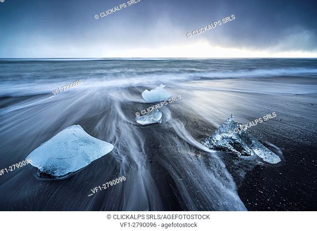 Ice blocks on the black sand beach in Jokulsarlon Glacier Lagoon, Eastern Iceland, Europe