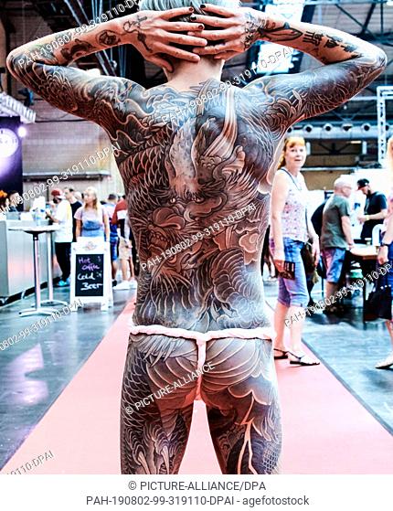 02 August 2019, Berlin: Ai-tse from Taiwan shows his almost completely tattooed body at the 29th Tattoo Convention. Photo: Annette Riedl/dpa