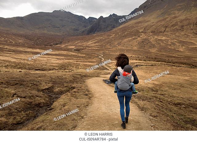 Mother carrying son in sling, Fairy Pools, near Glenbrittle, Isle of Skye, Hebrides, Scotland
