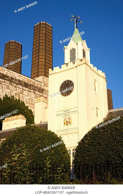 England, London, Greenwich. The clock tower at the riverside entrance to Trinity Hospital. The inscription below the clock reads 'Hospitale Sanctae et...