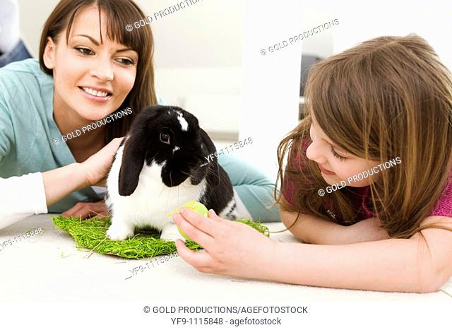 Mother and daughter with Easter Eggs and rabbit