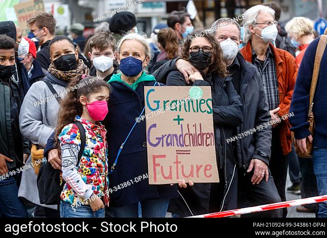 24 September 2021, Hamburg: Demonstrators hold a sign with the inscription ""Grannies + Grandchildren = Future"" at the climate strike demonstration of...