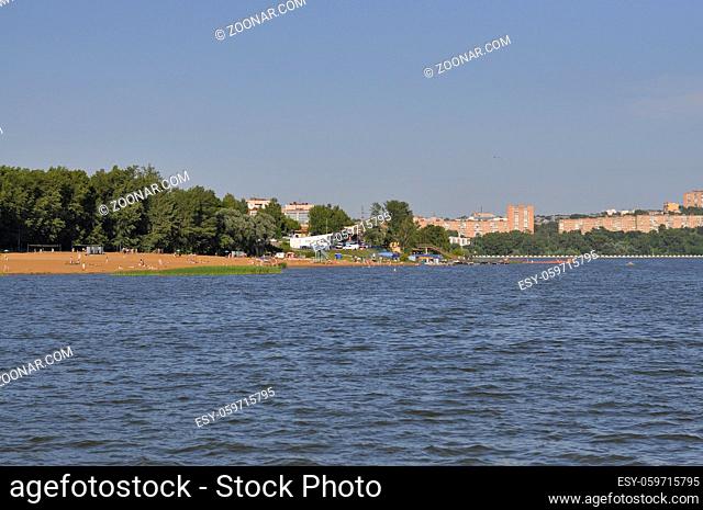 The lake on the shore of which the city stands. Urban landscape on the coastline