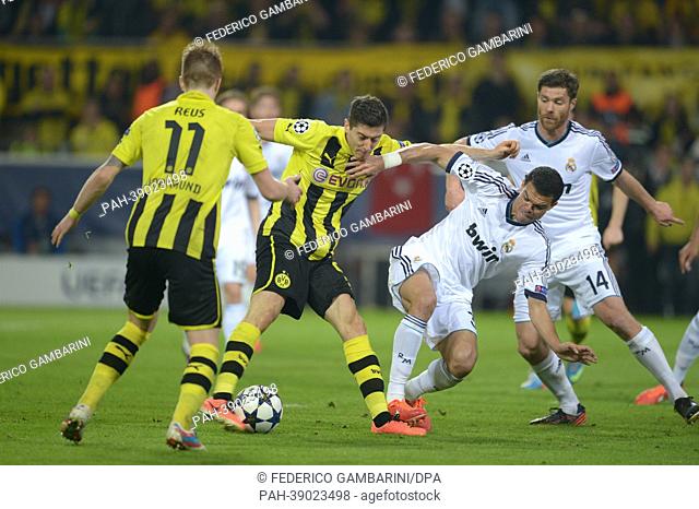 Dortmund's Robert Lewandowski (2-L) scores the goal 3-1 against Madrid's Pepe (2-R) during the UEFA Champions League semi final first leg soccer match between...