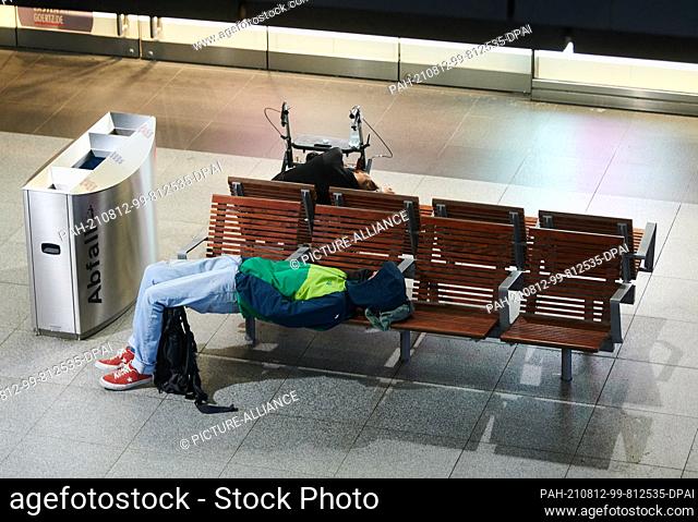12 August 2021, Berlin: People sleeping in the main station Berlin. The nationwide train driver strikes in passenger traffic will continue