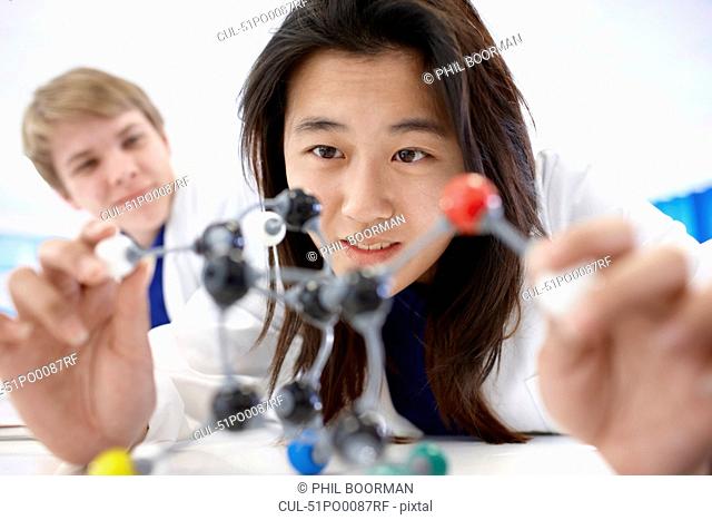 Student examining molecular model
