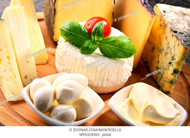 Different sorts of cheese on kitchen table