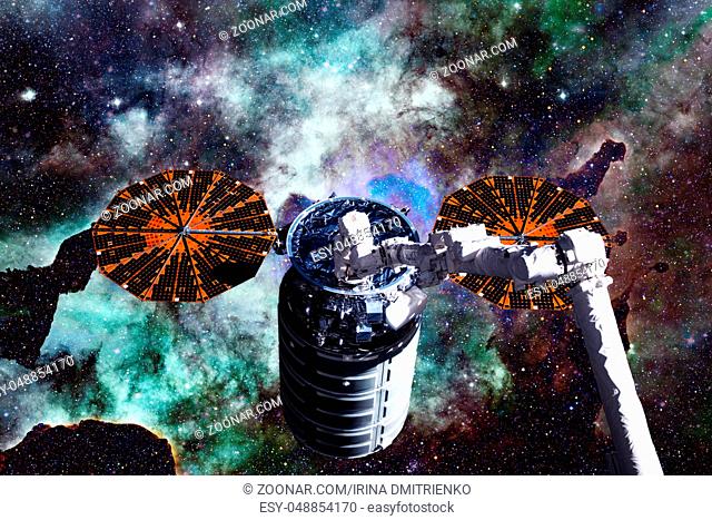 Cargo spacecraft - The Automated Transfer Vehicle over spiral galaxy. Elements of this image furnished by NASA