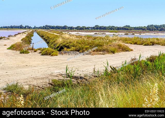 Saline in the Camargue area in southern France wich is showing pink salt evaporation ponds in sunny ambiance