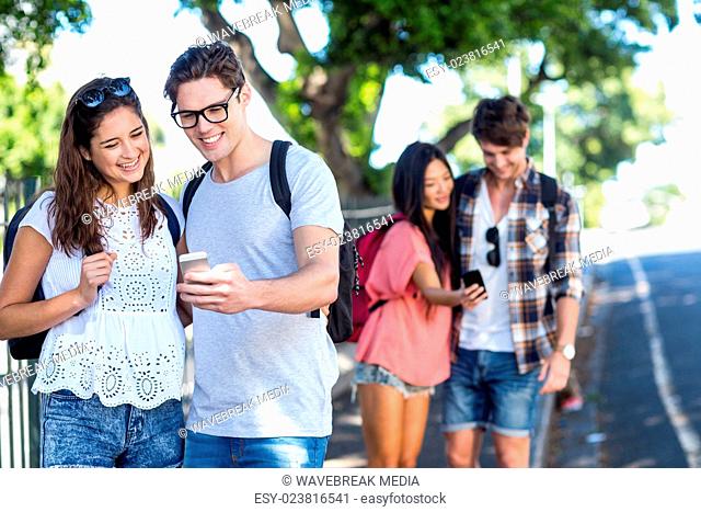 Hip couples checking at smartphone