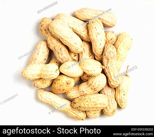 top view of pile of whole peanuts close up on gray ceramic plate