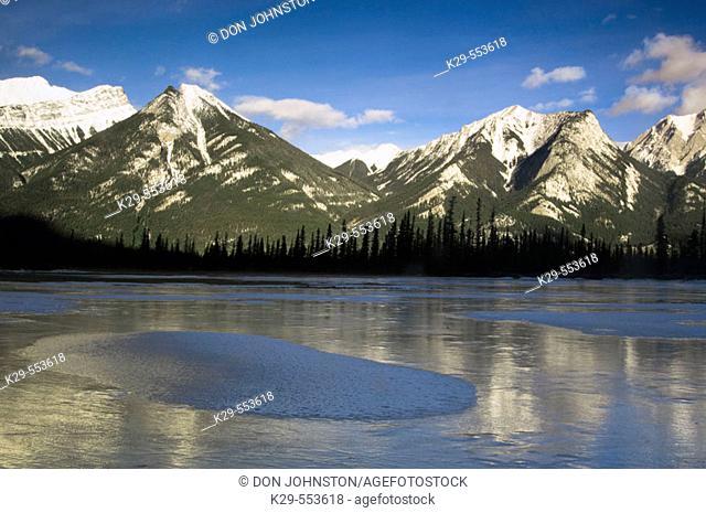 Frozen pond and SeSmet range in Jasper Flats. Alberta, Canada