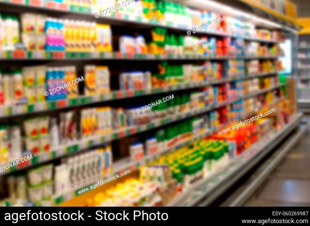 Defocus background grocery store shelves dairy department. Blurred photo of supermarket no people for design