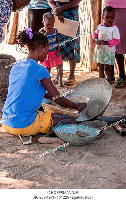 African woman sifting food