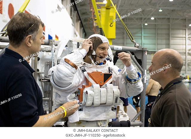 Astronaut Clayton C. Anderson, Expedition 15 NASA space station science officer and flight engineer, dons a training version of his Extravehicular Mobility Unit...