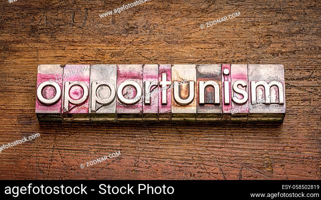 opportunism, the practice of taking advantage of circumstances, word abstract in gritty vintage letterpress metal type stained by printing ink against rustic...