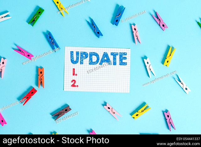 Handwriting text writing UPDATE. Conceptual photo make something more modern or up to date like software program Colored clothespin rectangle shaped reminder...