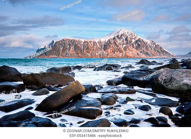 Rocky coast of fjord of Norwegian sea in winter. Skagsanden beach, Lofoten islands, Norway
