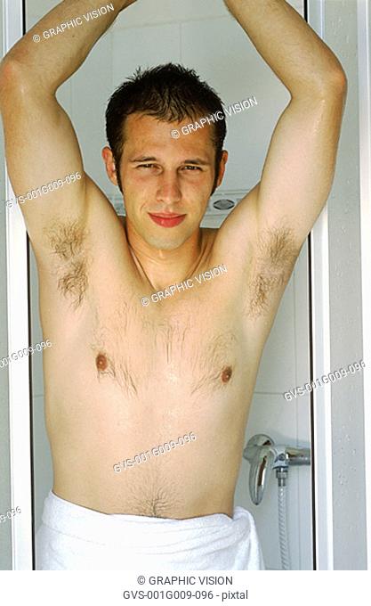 Young man standing in a shower