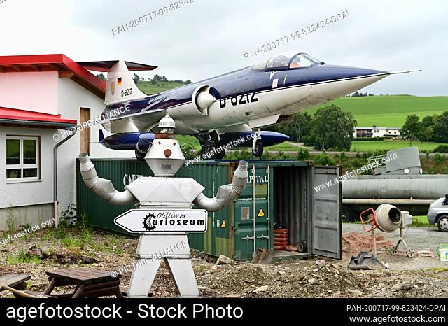 10 July 2020, Hessen, Willingen: A scrap robot and a Lockheed F-104 Starfighter are parked in front of the Curioseum. The Curioseum in Willingen is one of...