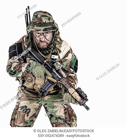 Special forces United States in Camouflage Uniforms studio shot. Holding weapons, wearing jungle hat, Shemagh scarf, painted face