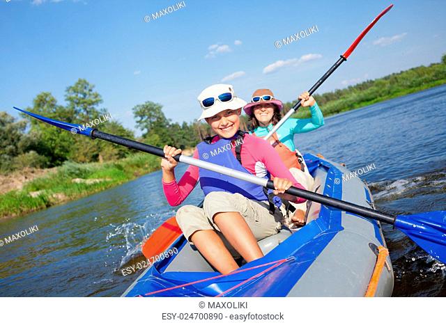 Summer vacation - Cute girl with mother kayaking on river
