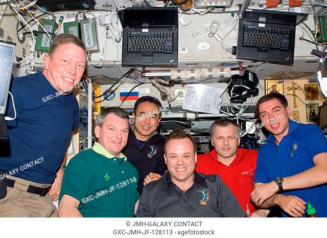 Expedition 28 crew members pose for a photo in the Zvezda Service Module of the International Space Station. Pictured from the left are NASA astronaut Mike...