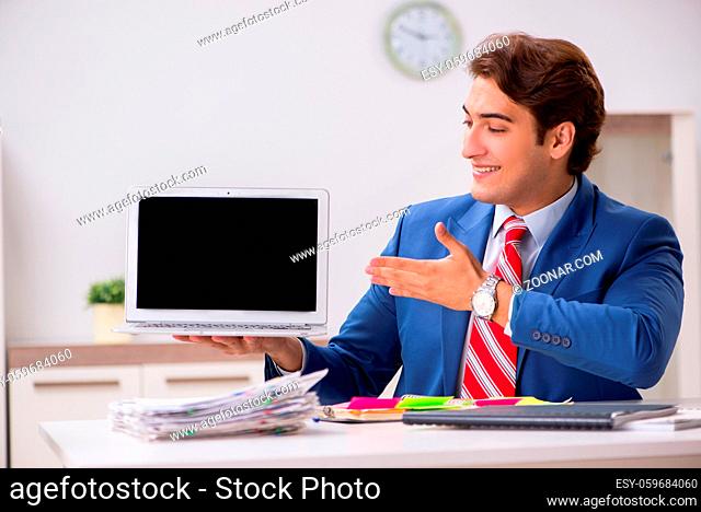 Young attractive businessman working in the office