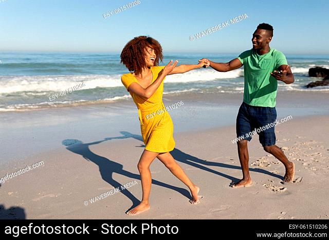 Mixed race couple having fun on the beach
