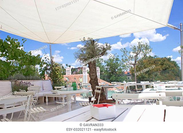 Outdoor restaurant terrace on roof with parasol