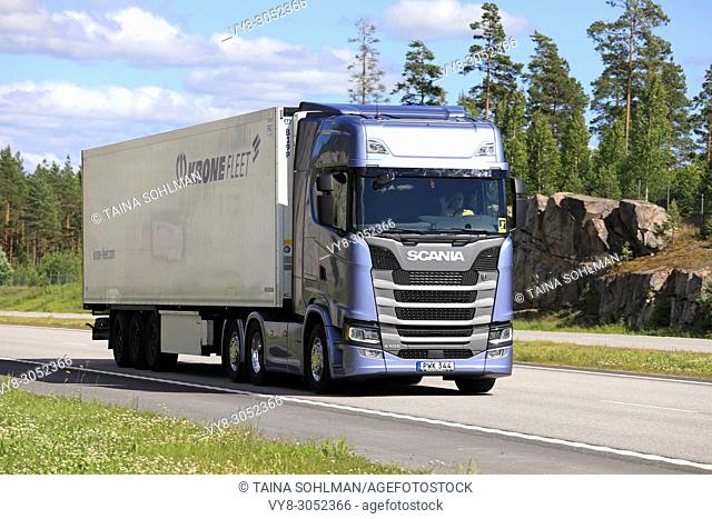 Ice blue Next Generation Scania S500 semi trailer delivers load along E18 motorway in South of Finland on a beautiful day of summer