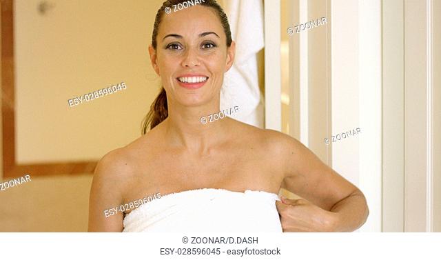 Happy woman holding towel around herself