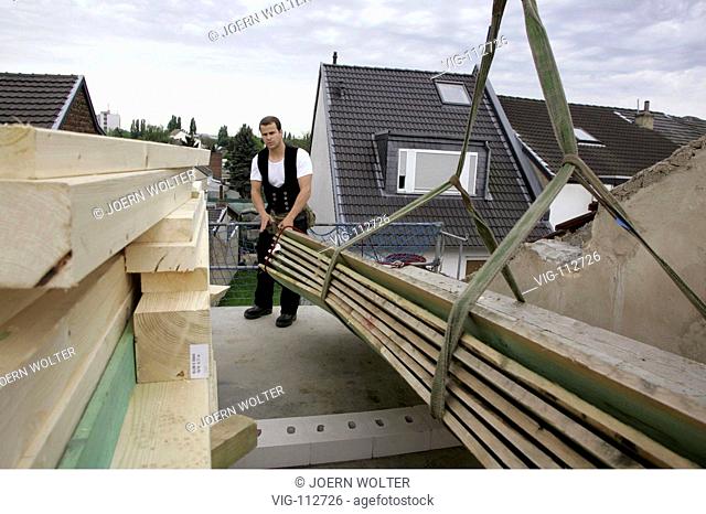Carpenter prepared erection of the roof timbering on the house. - BONN, GERMANY, 09/05/2005