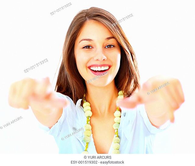 Portrait of beautiful young girl pointing at you with both hands over white background