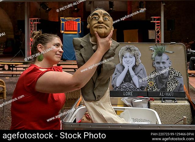 23 July 2022, Saxony-Anhalt, Halle (Saale): Puppeteer Julia Raab takes the figure of Erich Mielke out of the box. Her play ""Be ready! Always ready!"" looks...