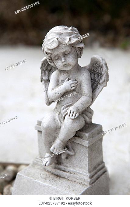 Stone angel with wings at the grave