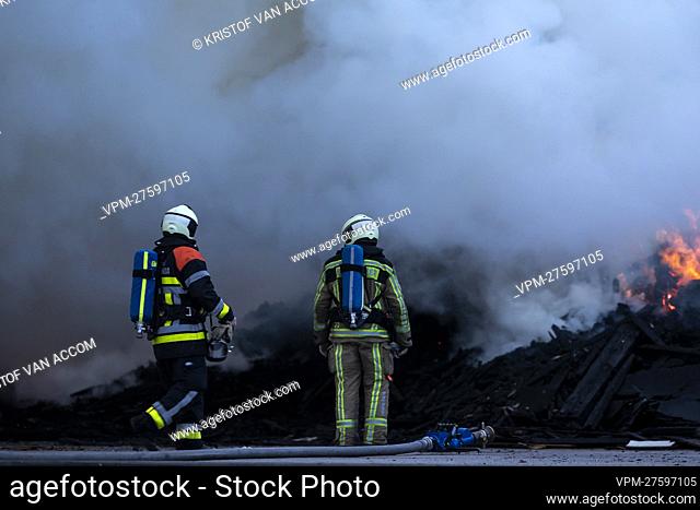 Fire fighters pictured at the site of IOK recycling and waste management company, in Beerse, Monday 28 March 2022. BELGA PHOTO KRISTOF VAN ACCOM