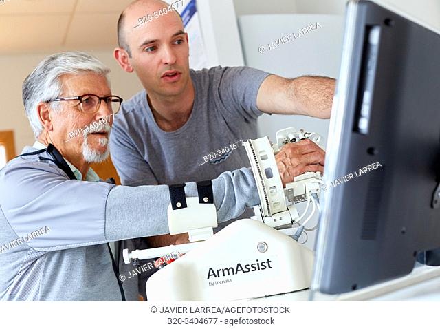 Patient with assistive robot for upper limb rehabilitation, The robot ArmAssist allows passive, assisted and active training of the arm and hand
