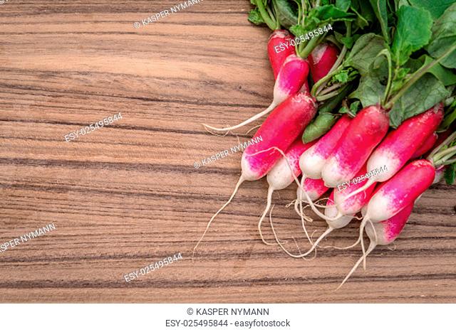 Radishes on a dark wooden table