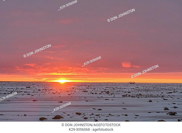 Sunset skies over Hudson Bay at freeze-up, Wapusk NP, Cape Churchill, Manitoba, Canada