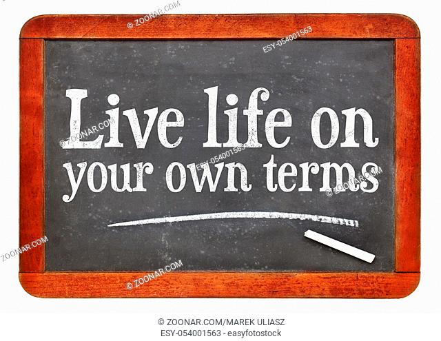 Live life on your own terms - white chalk text on a vintage slate blackboard
