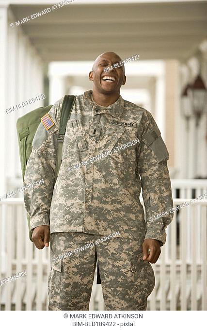 African man in military uniform laughing