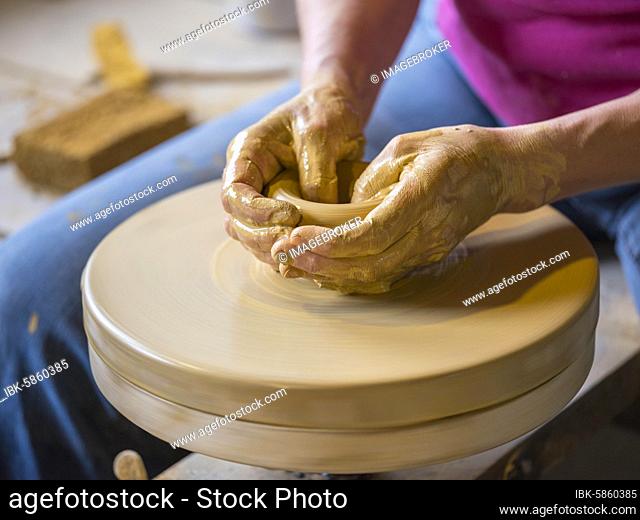 Potter turning a vase with her hands on the potter's pane, Handicraft, Arts and crafts, Oldenburger Münsterland, Lower Saxony, Germany, Europe