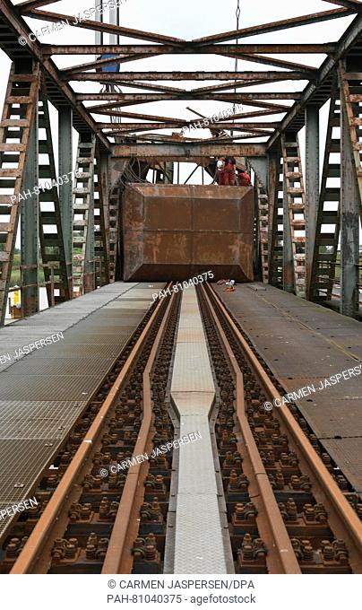Employees of a recovery company work on the sash weight of the Friesenbruecke bridge that was damaged in a collision, in Weener, Germany, 08 June 2016