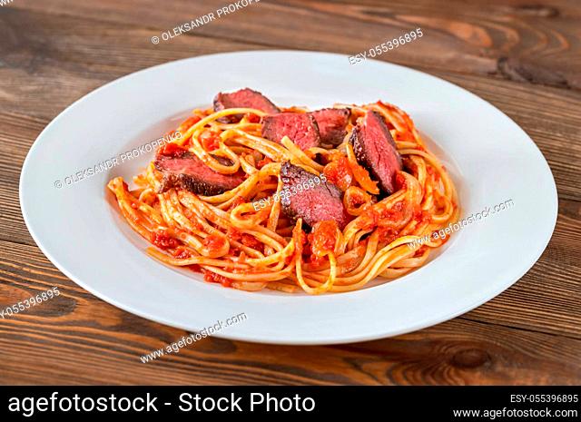 Portion of beef steak linguine pasta