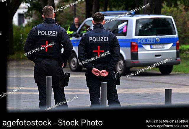 24 October 2023, Thuringia, Erfurt: Police officers stand to protect a key witness from the left-wing scene during his testimony before an investigative...