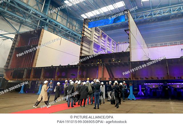 15 October 2019, Mecklenburg-Western Pomerania, Rostock: The Neptun shipyard in Warnemünde celebrates the laying of the keel for the engine section of the...