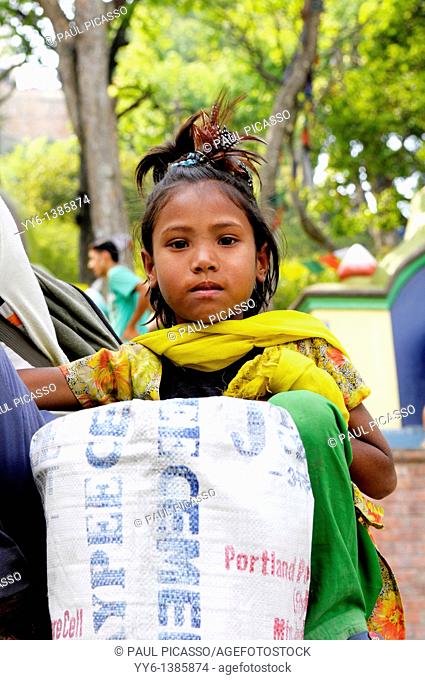 little nepalis girl collecting plastic bottle for recycling , the nepalis , life in kathmandu , kathmandu street life , nepal