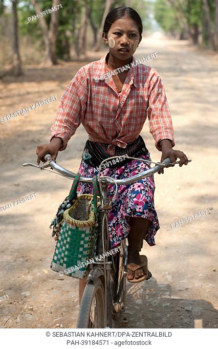 Myanmar A girl is riding a bicycle in Inwa, Myanmar, on 02.04.2013. Photo: Sebastian Kahnert | usage worldwide. - Bagan/Birma